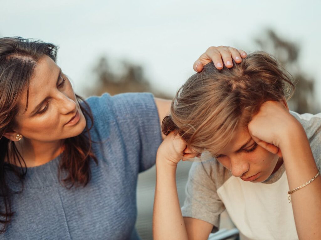 pexels-photo-8550841 A mother offers support to her discouraged teenager son, portraying love and understanding.